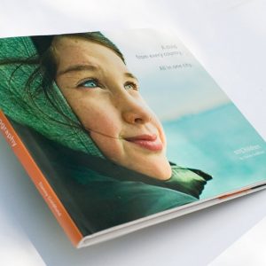 NYChildren Photography Book by Danny Goldfield. Features a 12 year old girl's face on the cover as shee looks into the distance, the future.