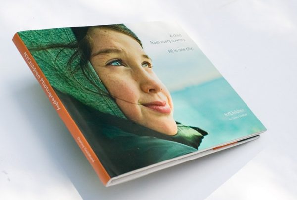 NYChildren Photography Book by Danny Goldfield. Features a 12 year old girl's face on the cover as shee looks into the distance, the future.