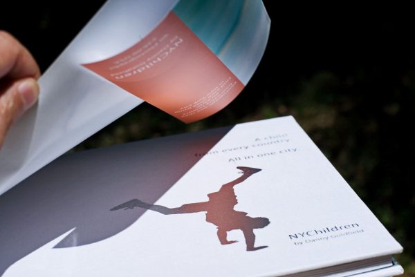 NYChildren Photography Book by Danny Goldfield. Under the dust jacket is white linen hardback cover with silver embossed logo and title.